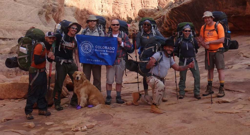 a group of veterans pose for a picture on an expedition with outward bound